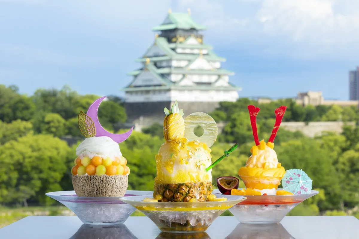 Three samurai-themed shaved ice desserts with Osaka Castle in the background