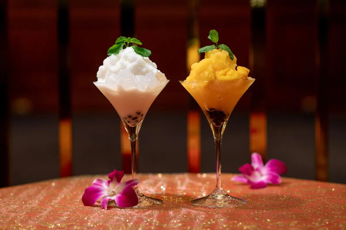 Mango and Coconut frozen cocktails with tropical garnishes