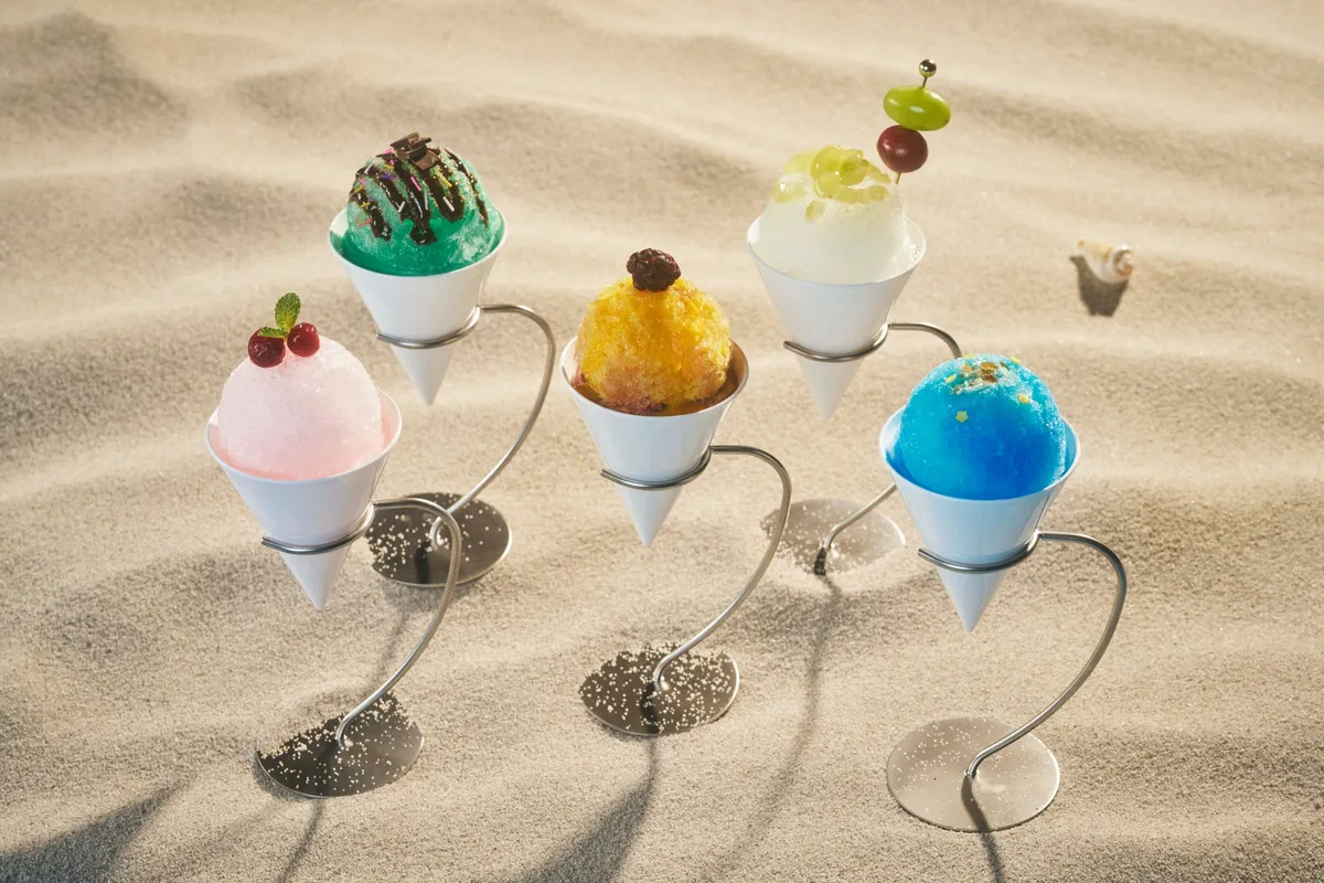 A selection of vibrant snow cones served on sand