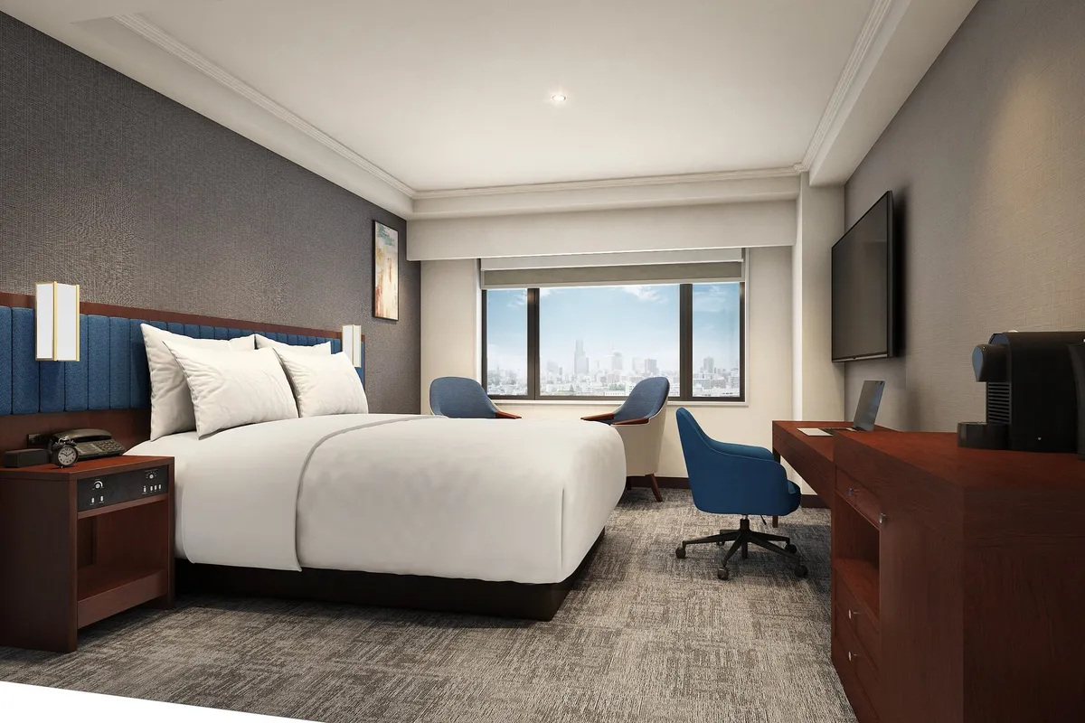 A modern guest room with a desk and blue accents