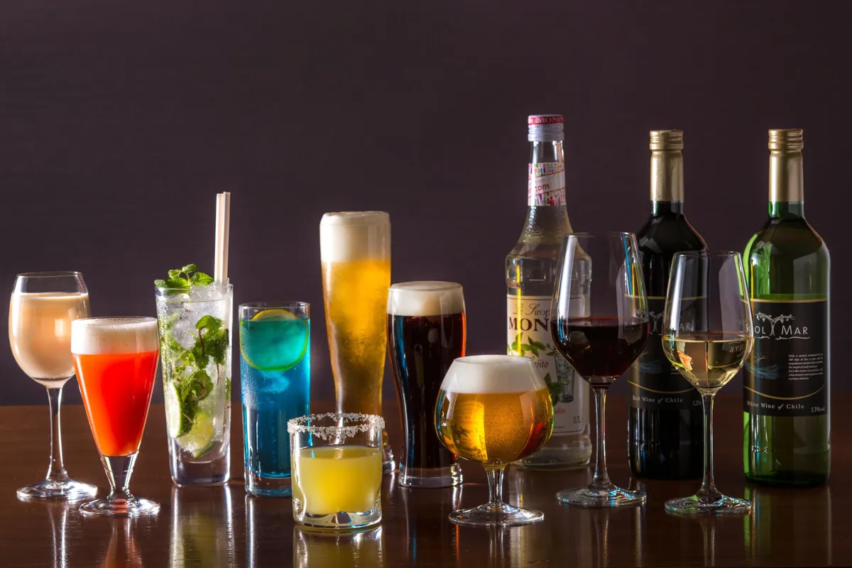 An array of colorful cocktails, craft beers, and wine bottles on a bar