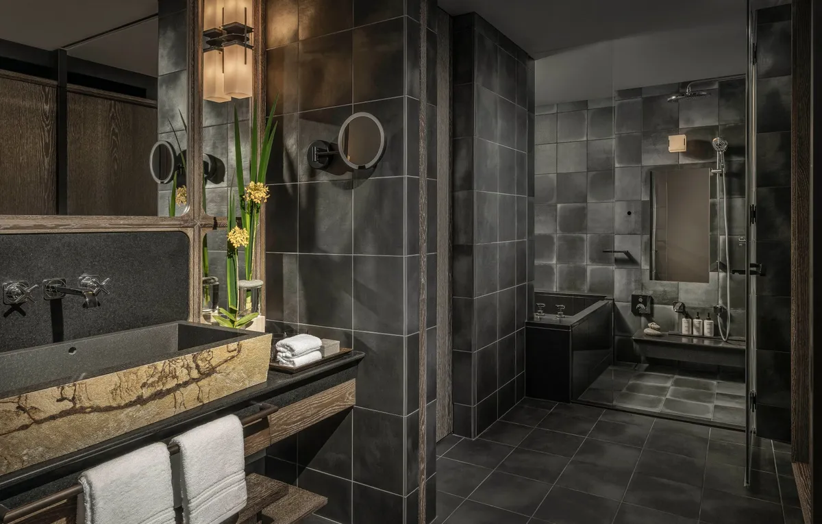 Stone-tiled bathroom with deep soaking tub