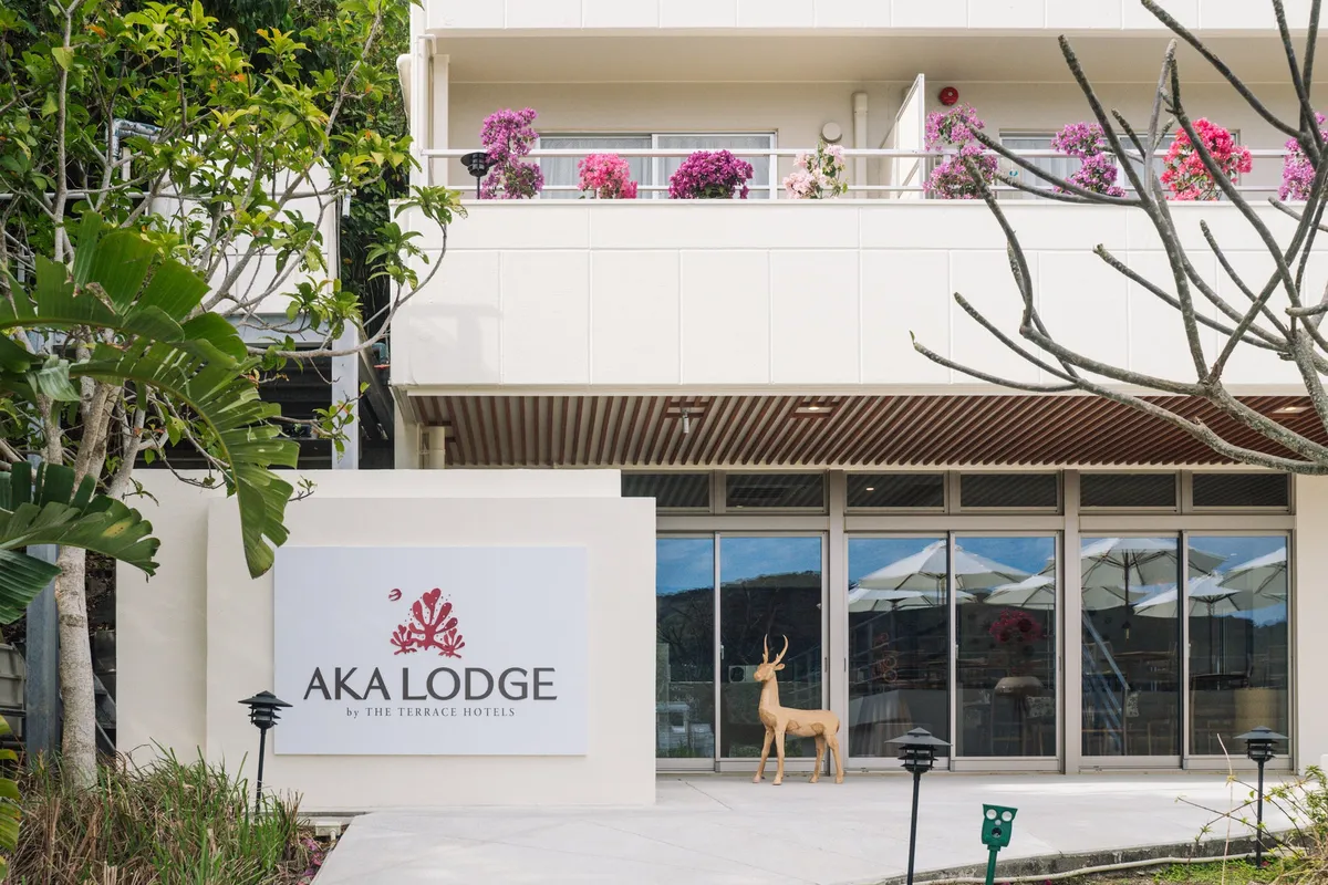The exterior entrance of AKA LODGE with a deer statue
