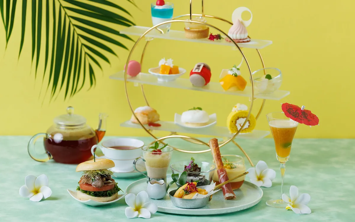 A spread of savory dishes including a Wagyu burger and grilled abalone.