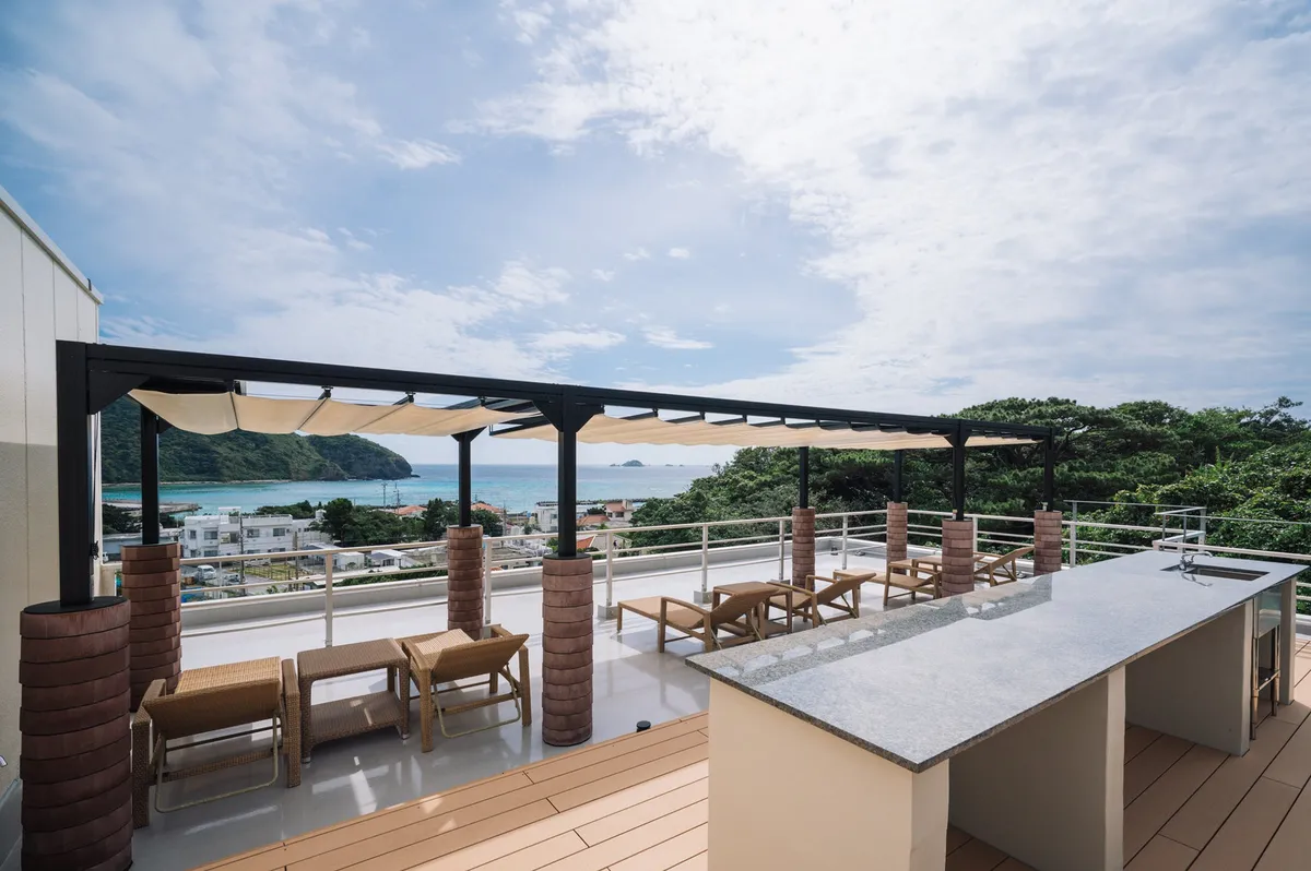 Lounge chairs on a rooftop deck overlooking the ocean