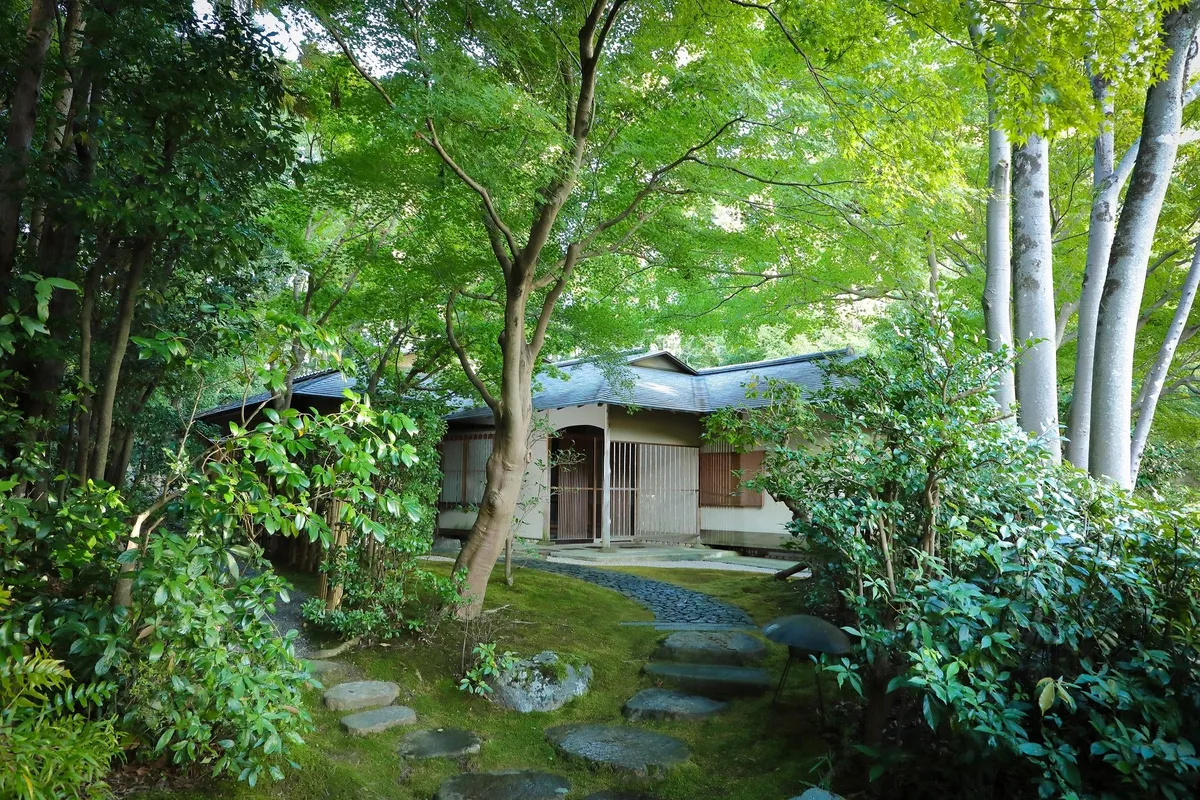 The exterior of the Saryo tea house among green trees