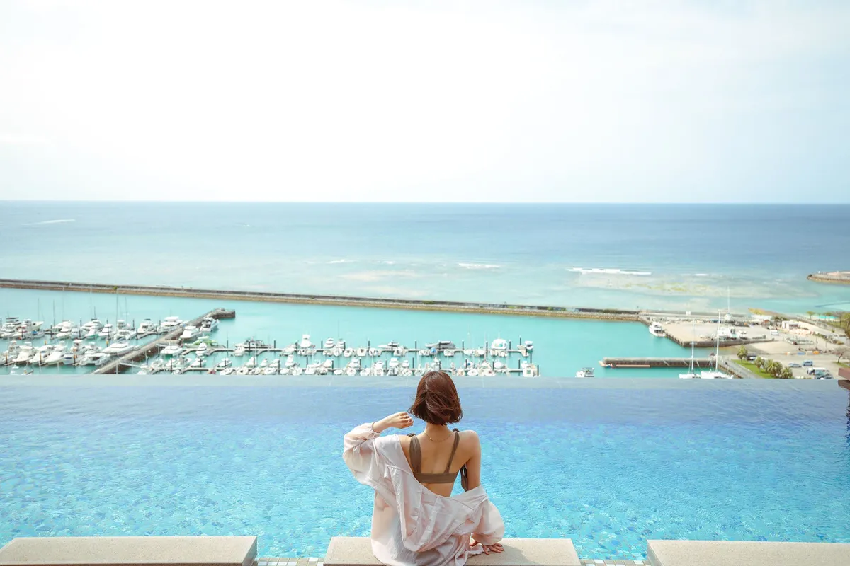 A guest at the infinity pool overlooking the ocean