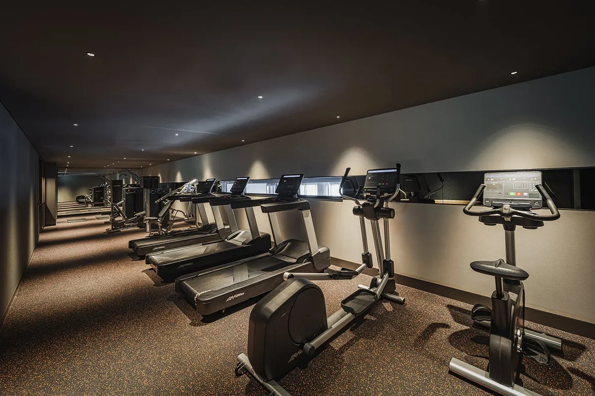 Fitness center with cardio equipment and city views