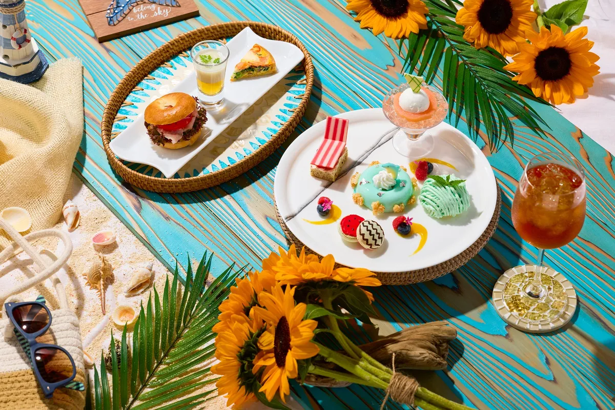 Summer Vacation Afternoon Tea spread with sunflowers and beach-themed sweets