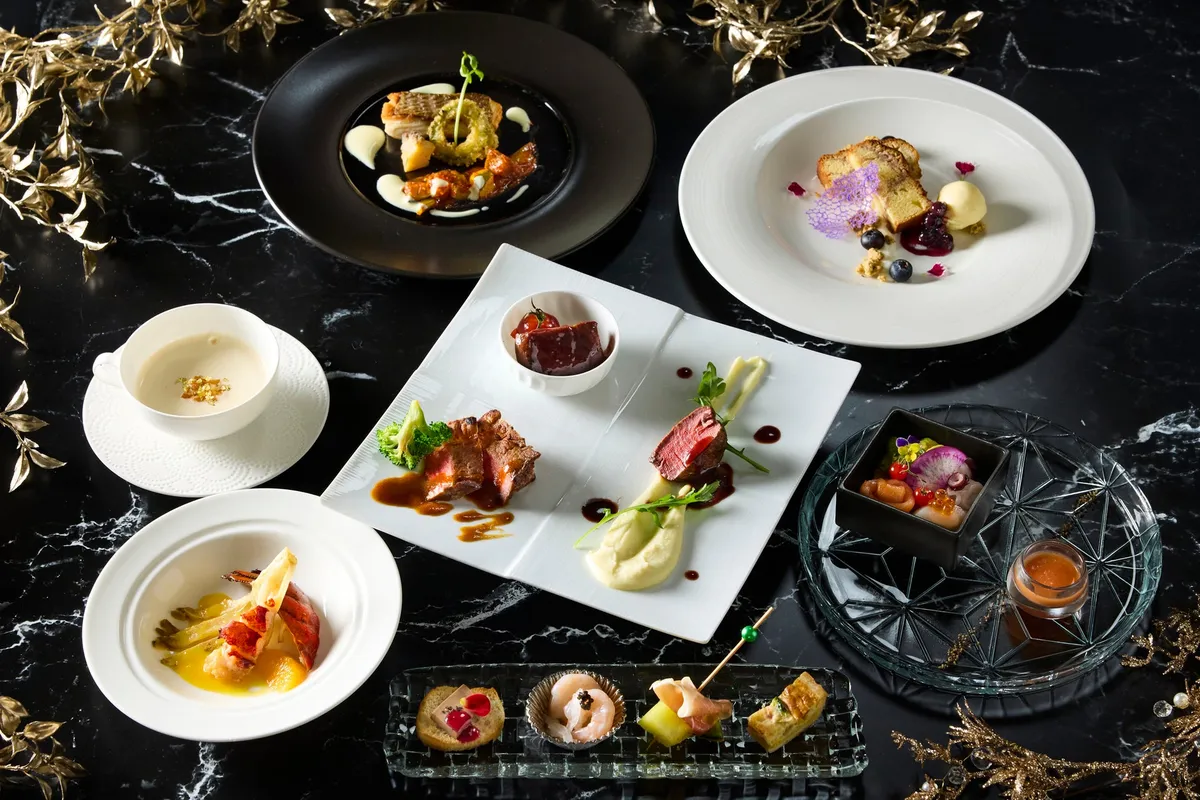 A seven-course summer dinner spread on a dark marble table