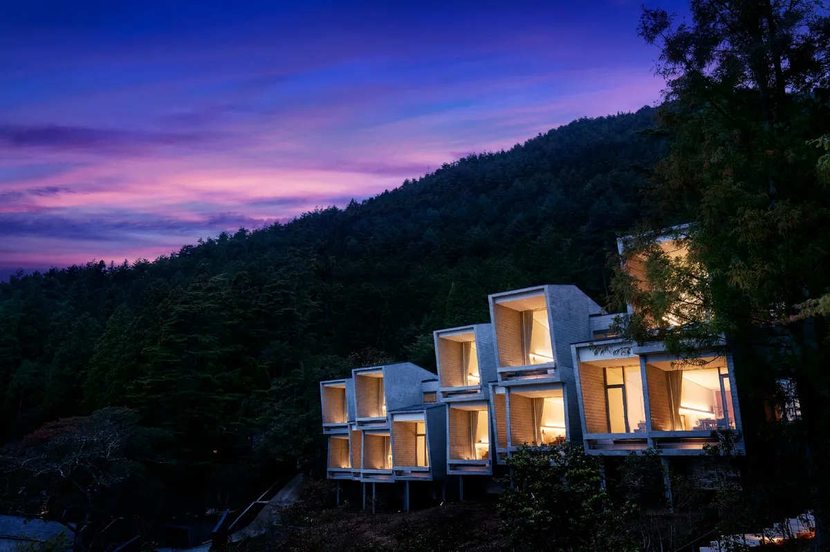Concrete cabin structures at Hoshinoya Fuji at dusk