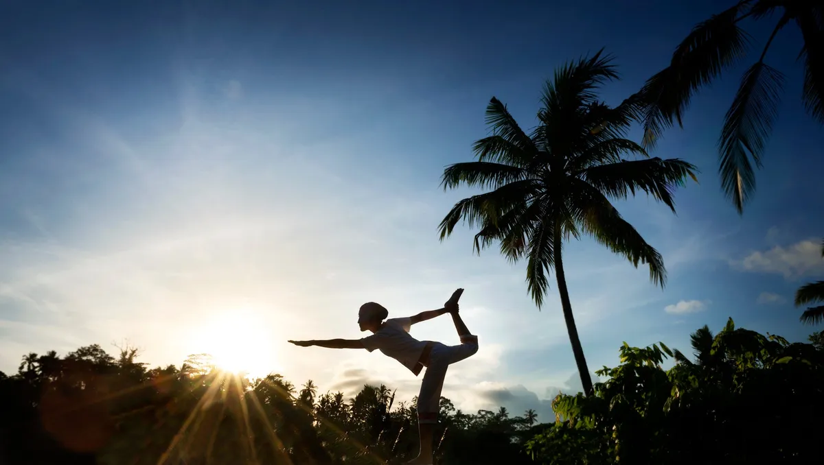 A guest practicing yoga at sunrise