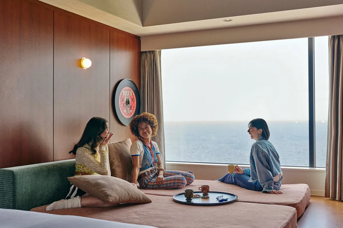 Guests relaxing in an ocean-view room at 1955 Tokyo Bay