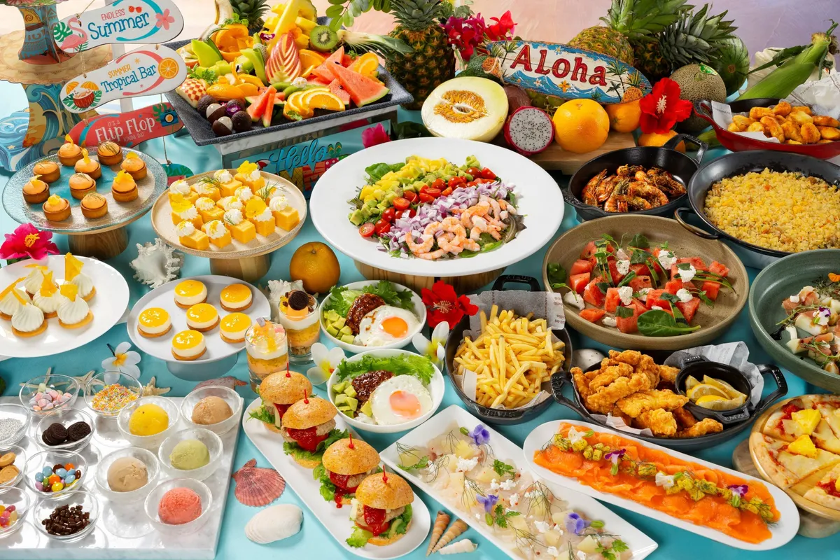 A spread of Hawaiian dishes including poke, loco moco, and tropical fruits