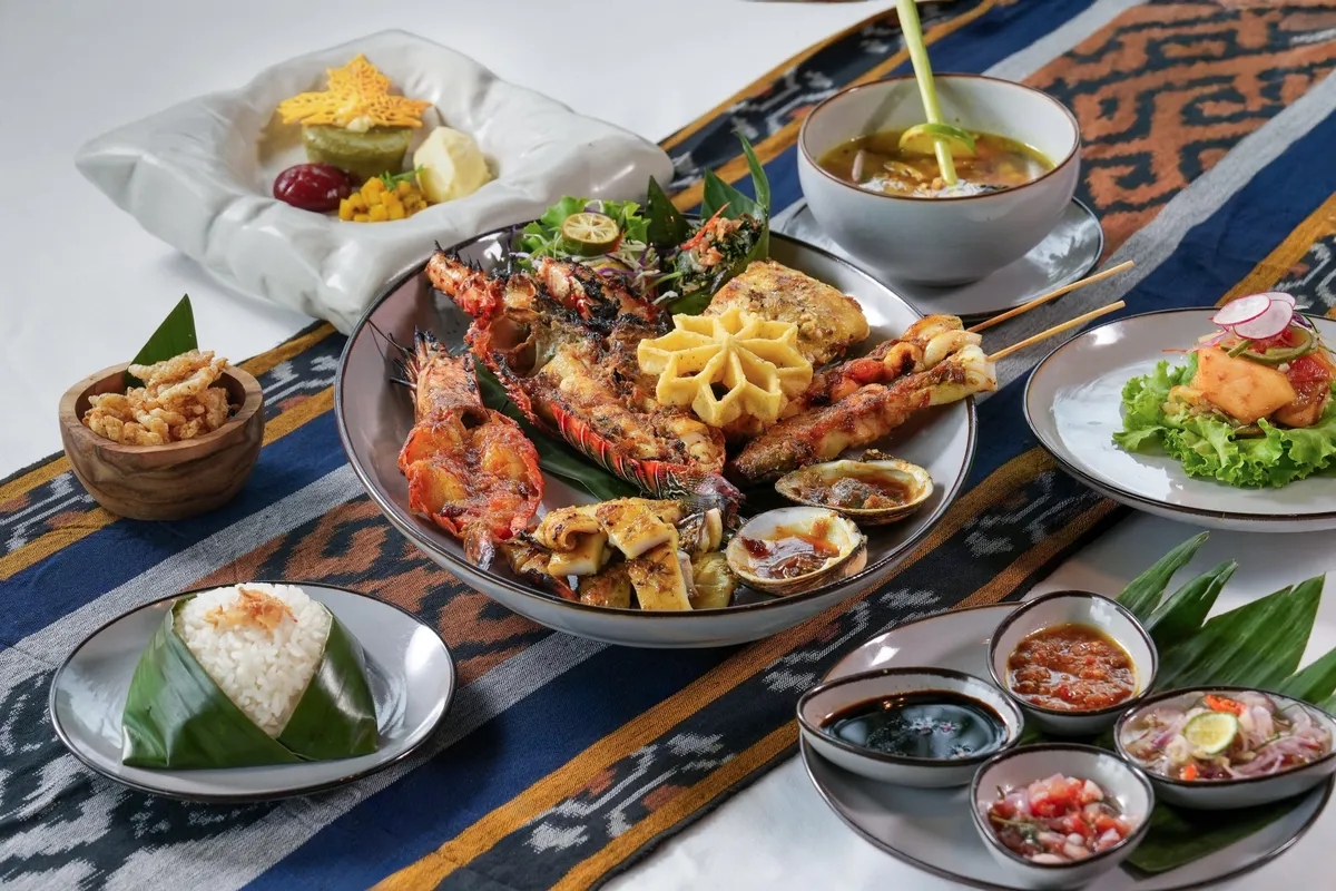 Seafood BBQ platter with lobster and traditional sides
