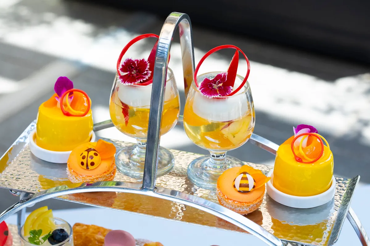 Close-up of the top tier featuring peach jelly and mango desserts