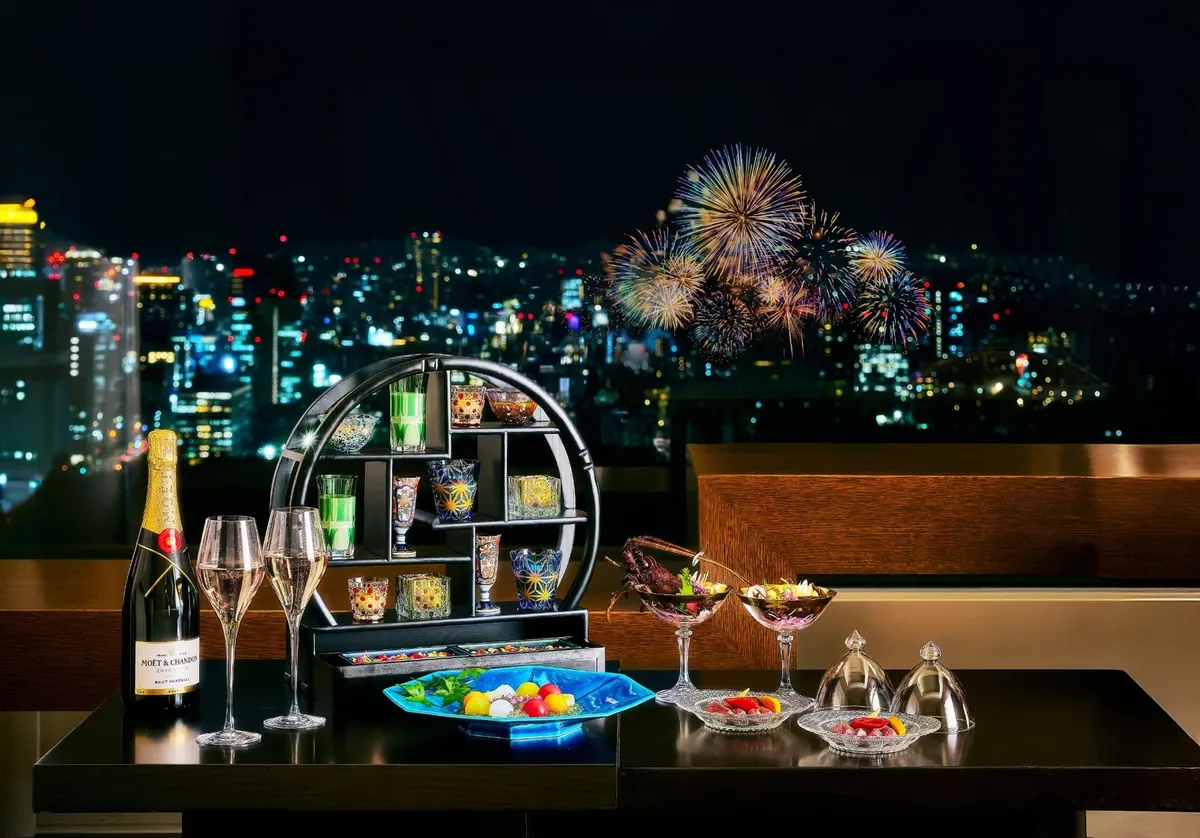 In-room dining setup with champagne and a view of fireworks