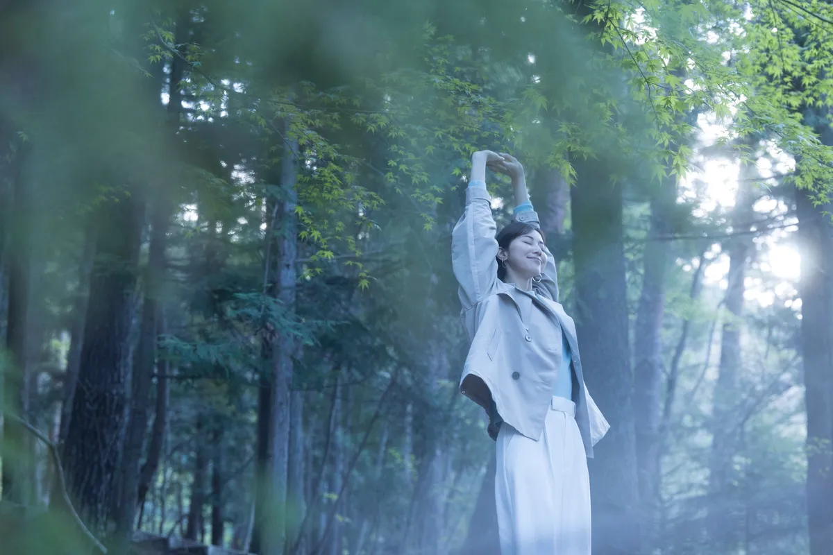 A guest stretching in a misty forest