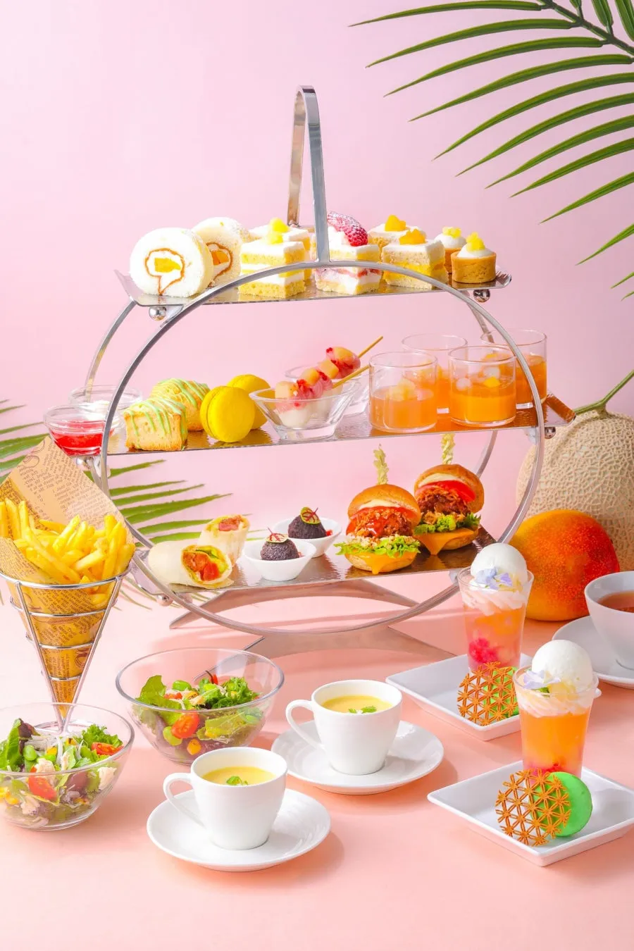 A vertical view of the afternoon tea service with a pink backdrop