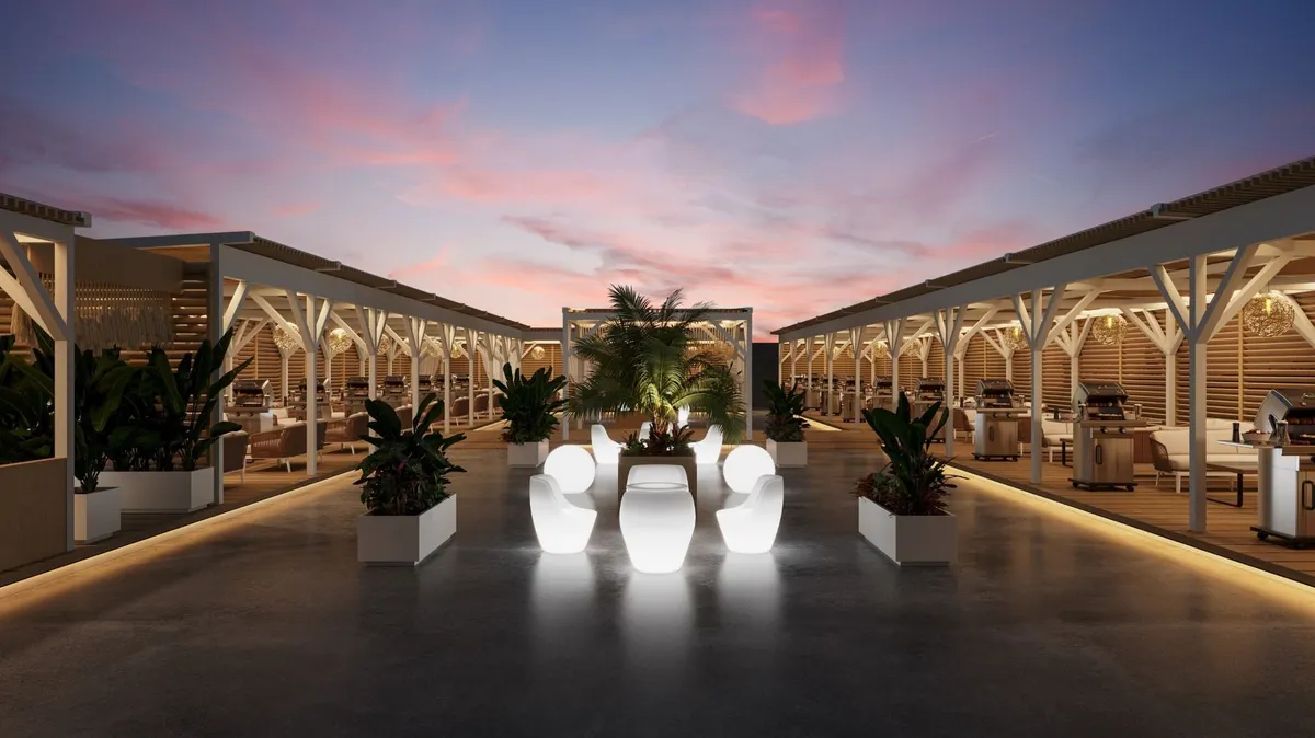 The illuminated rooftop terrace with white furniture at sunset