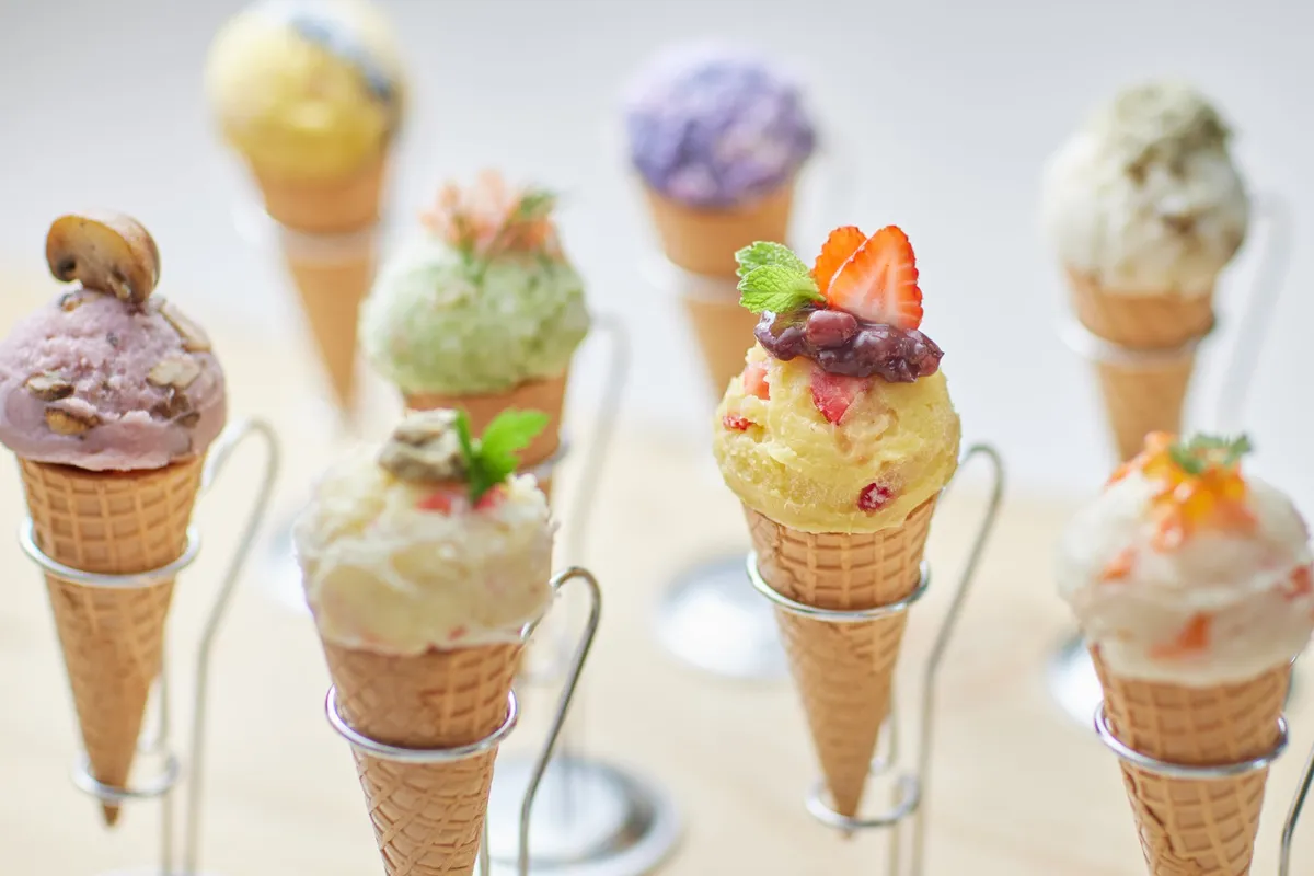 Close-up of various potato salad gelato cones with savory and sweet toppings