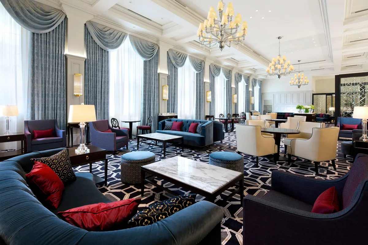 The interior of the Lobby Lounge with high ceilings and chandeliers