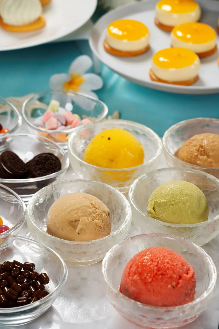 A variety of colorful ice cream and sorbet scoops with toppings