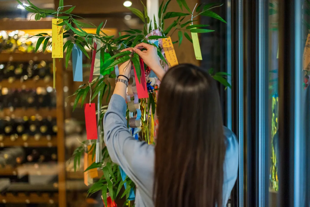 Guest hanging a tanzaku wish