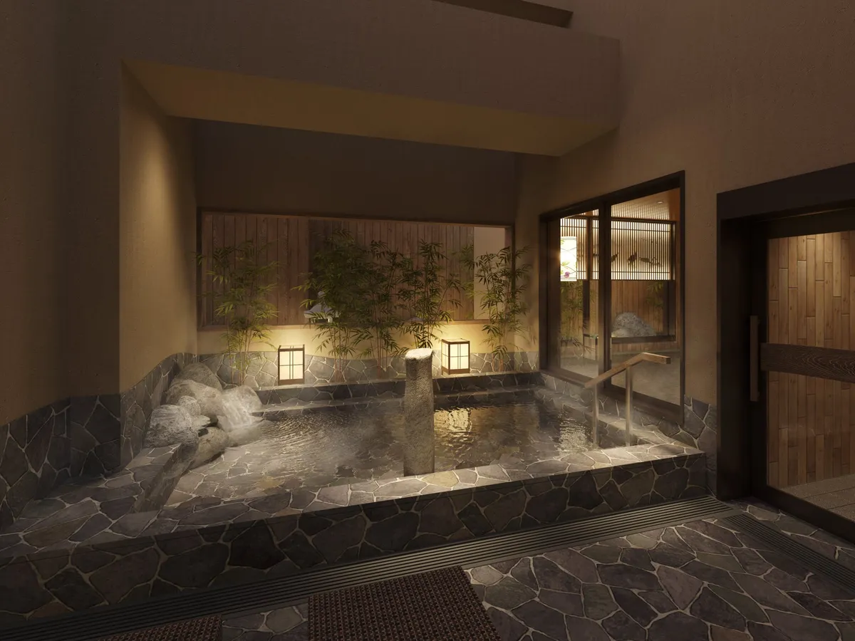 Stone-lined open-air bath with bamboo accents and lanterns