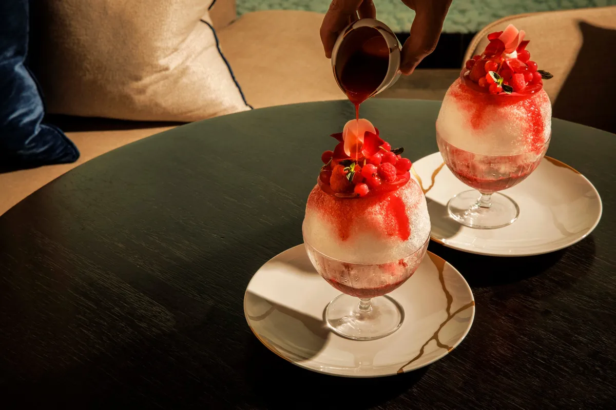 Pouring berry syrup over the seasonal shaved ice