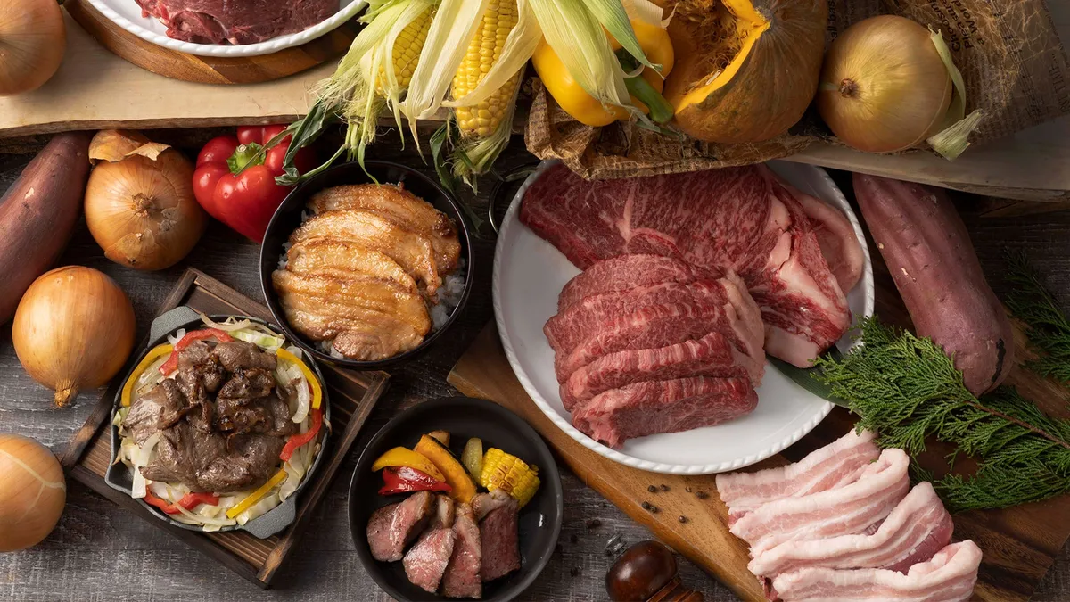 Display of raw and grilled meats with seasonal vegetables