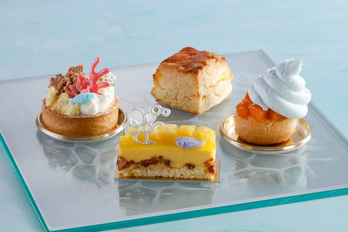 Middle-tier sweets including coral-themed tarts and tropical mousse