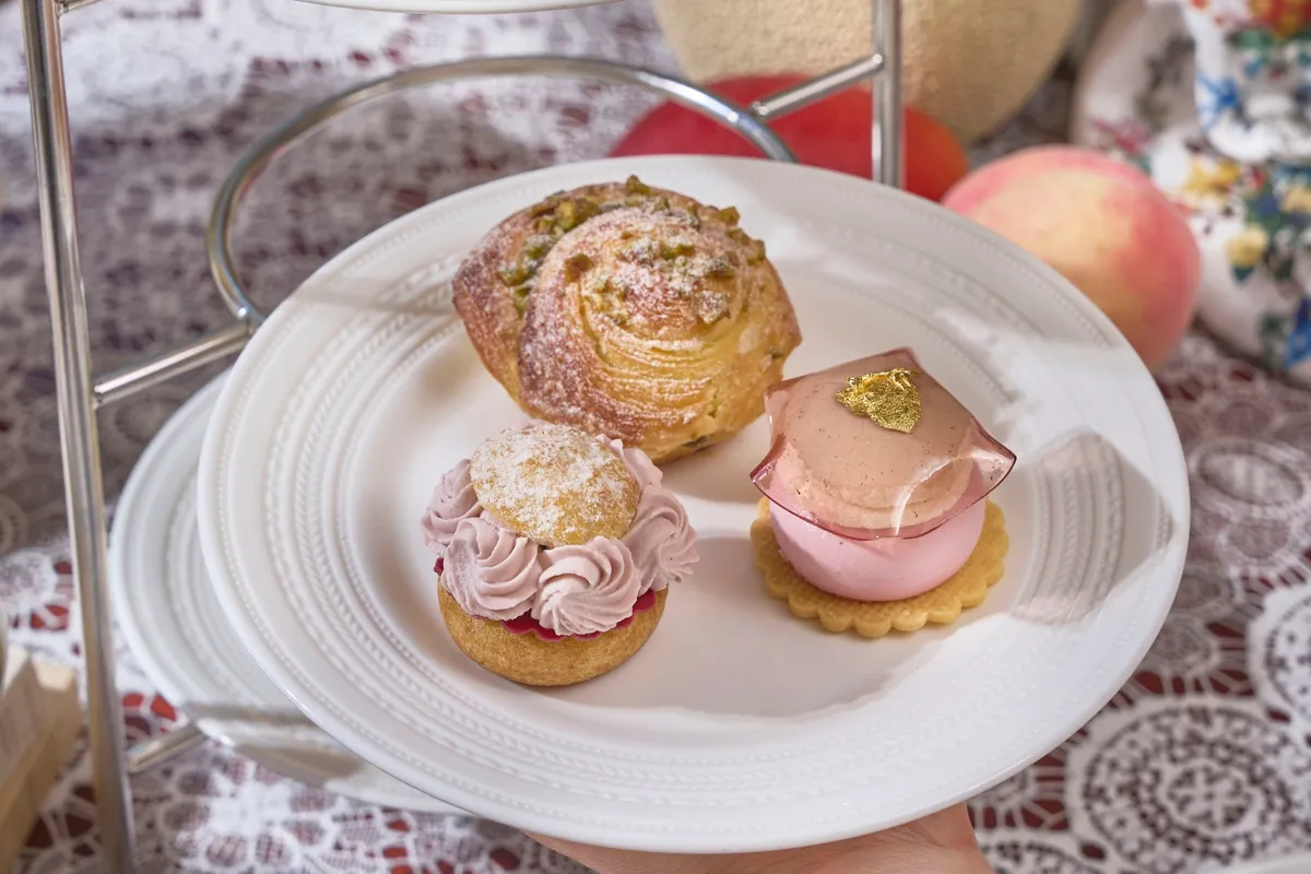 Middle tier with cream puffs and macarons