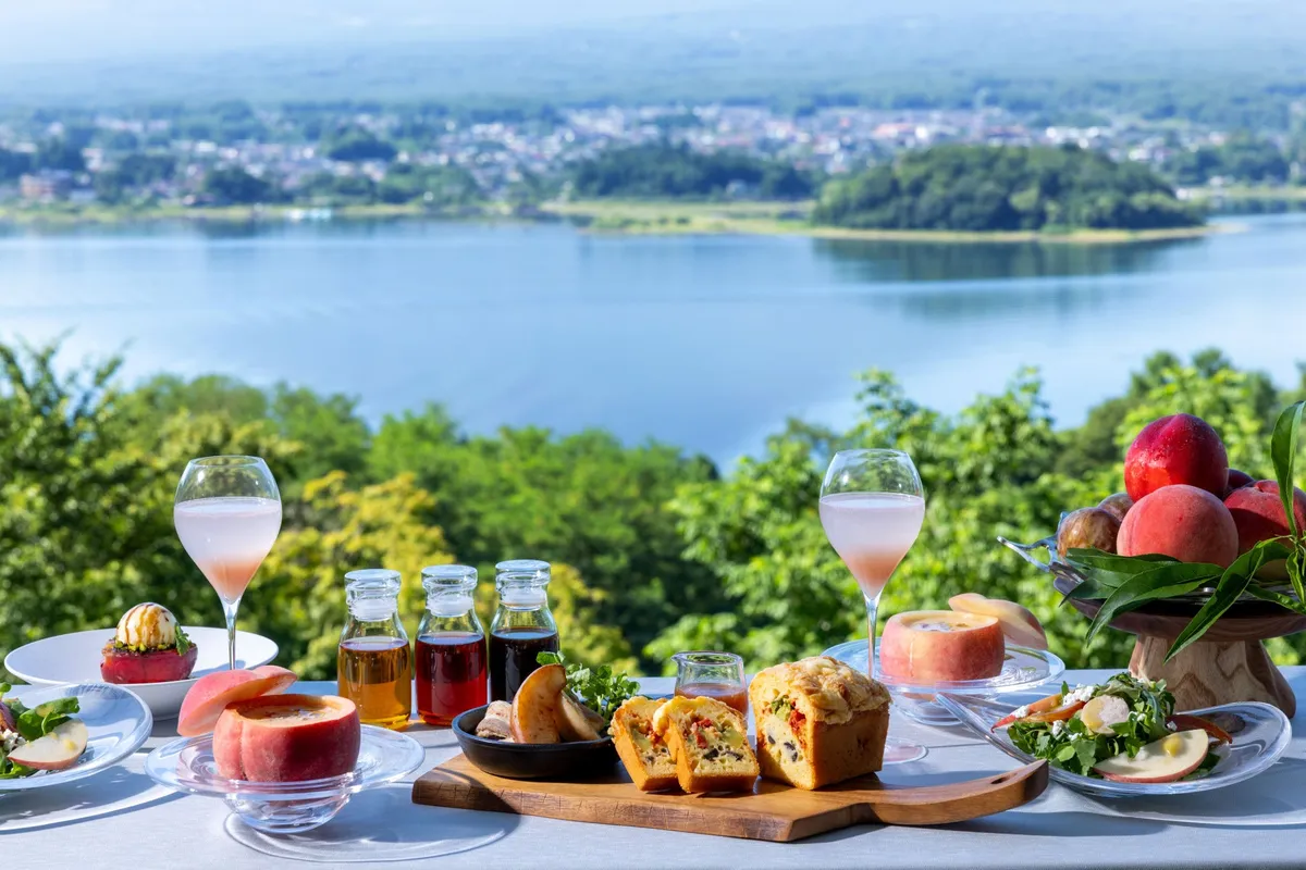 Breakfast spread with peaches on a terrace overlooking Lake Kawaguchi