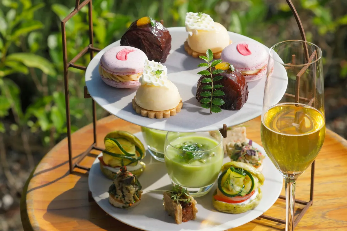 Close-up of afternoon tea stand with macarons and mousse