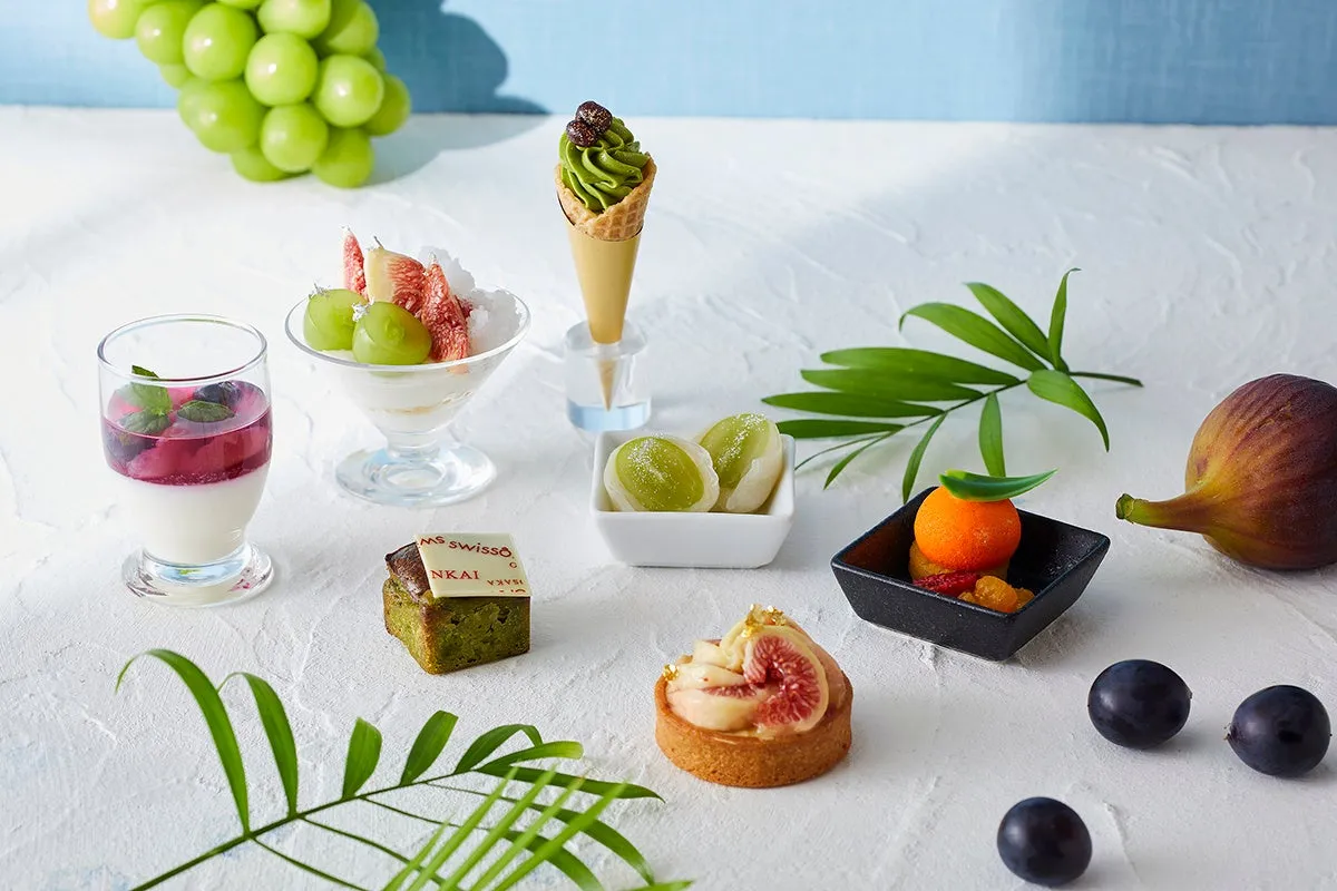Close-up of seasonal sweets including fig tarts and grape parfaits