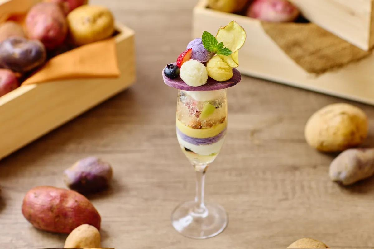 A multi-layered potato salad gelato parfait in a tall glass