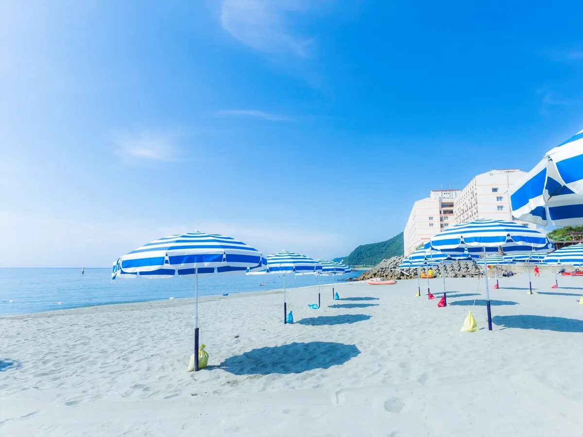 Blue and white striped umbrellas on the private beach