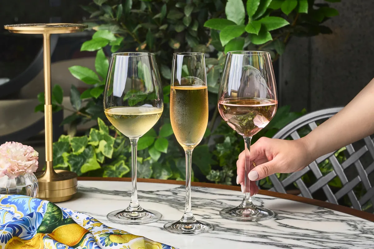 Glasses of white wine, champagne, and rosé on a marble table