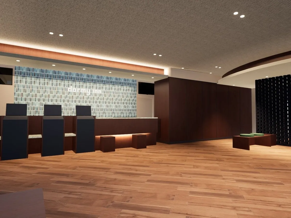 Hotel lobby with wooden floors and a dark-toned reception desk