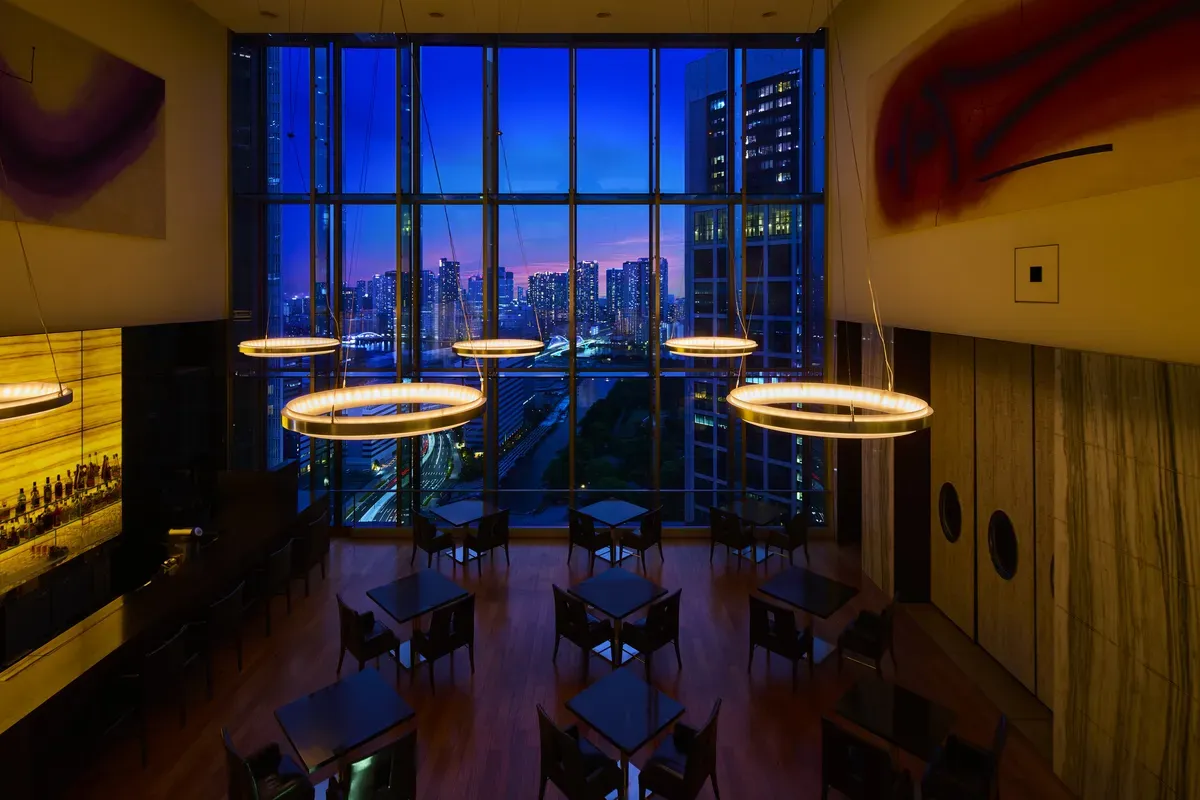 High-ceilinged bar lounge with panoramic Tokyo skyline views