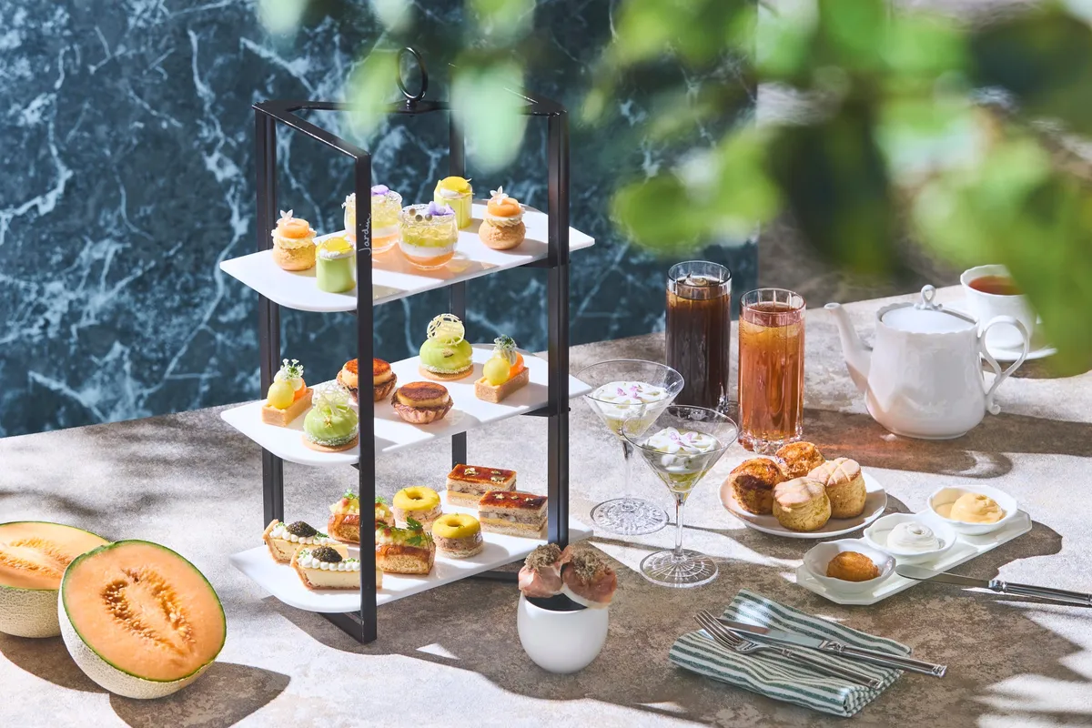Full afternoon tea stand with melon desserts and savory items