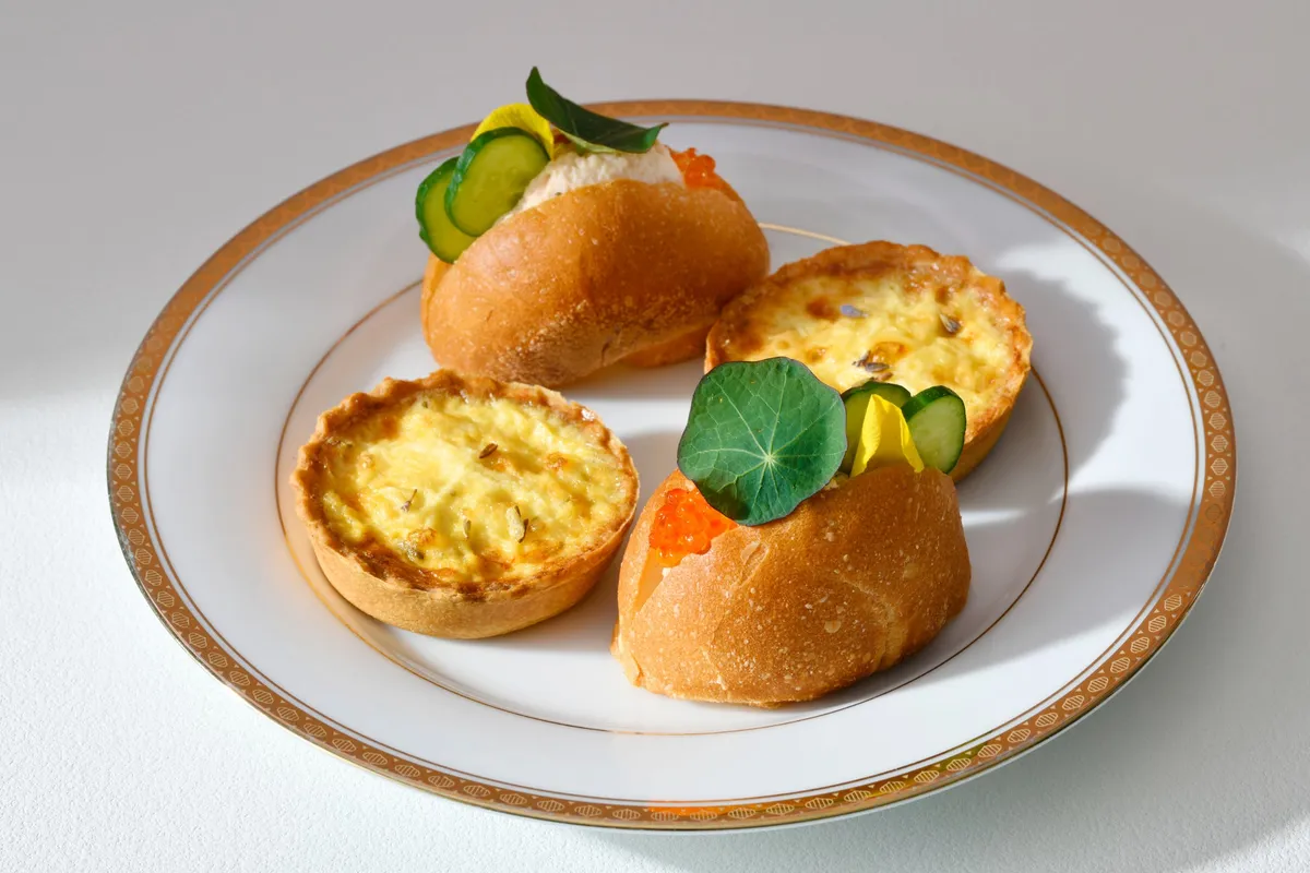Bottom tier with quiche and salmon sandwiches