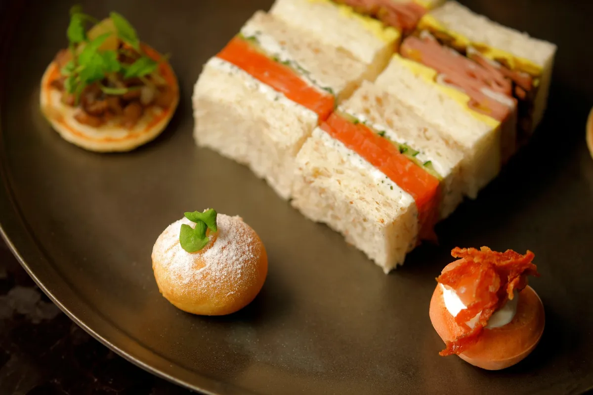Savory items including sandwiches and blinis