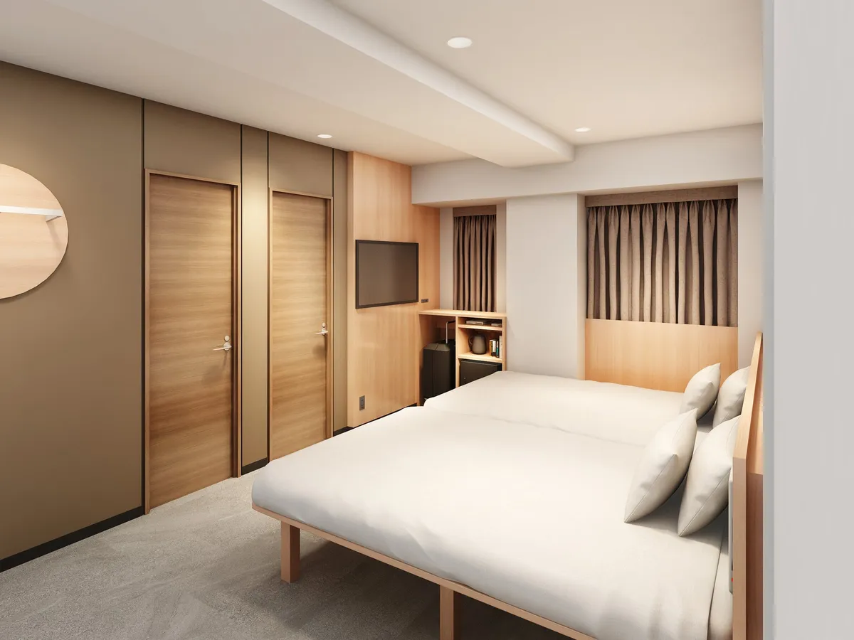 A room featuring two large twin beds side by side