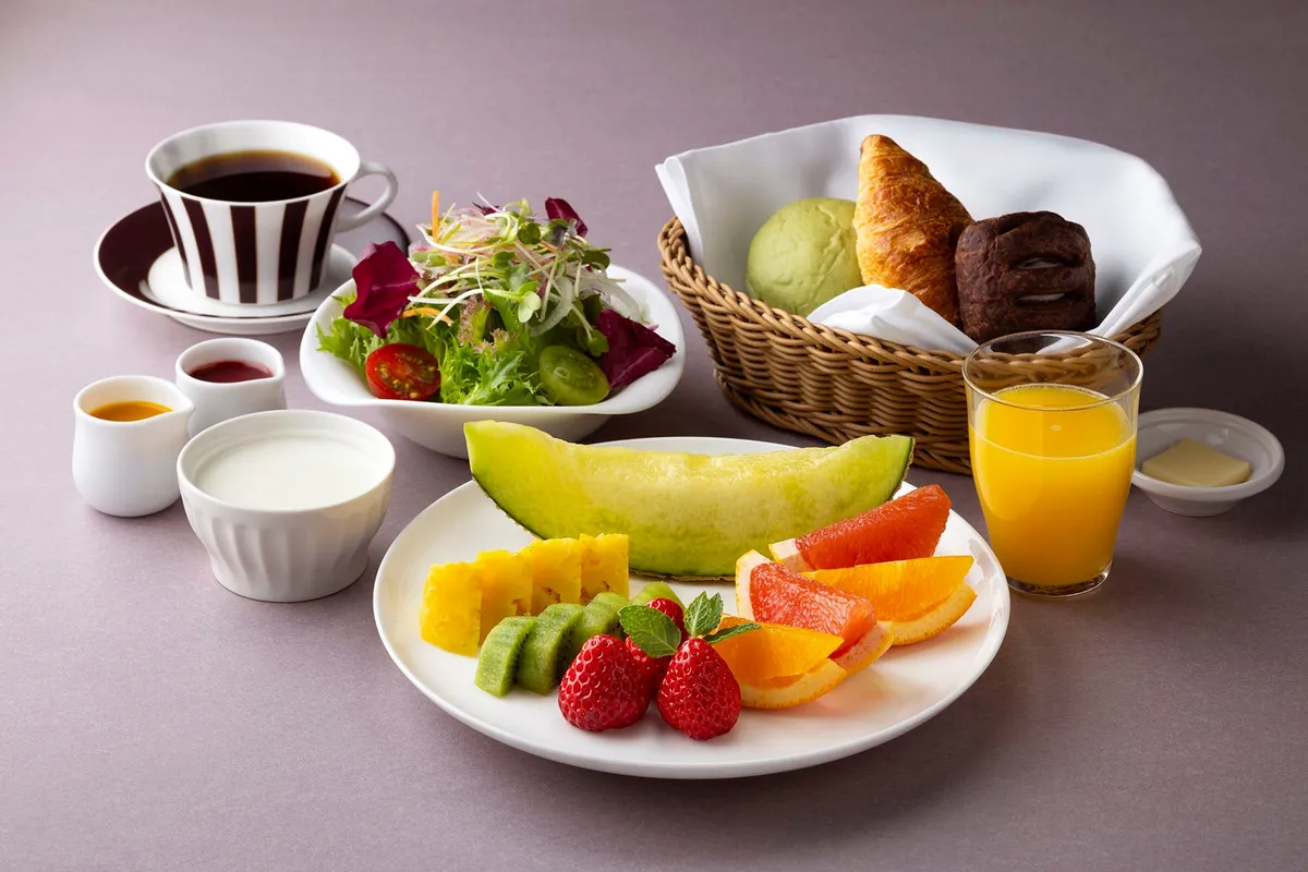 Continental Breakfast set with fruit, pastries, and juice