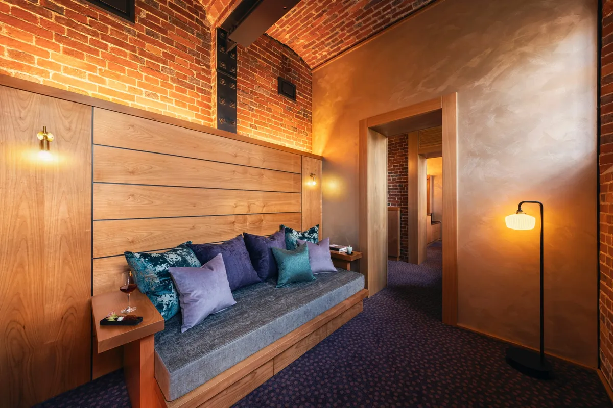 Interior of a suite featuring brick walls and wood paneling