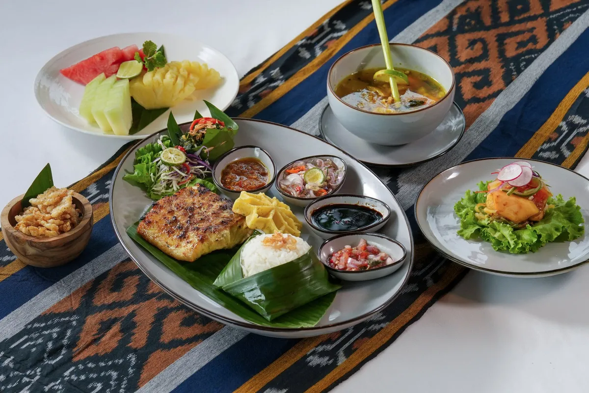 Local seafood set including grilled fish and condiments