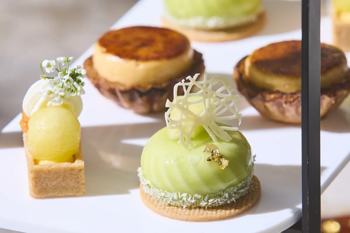 Close-up of green melon tart and glazed pastries