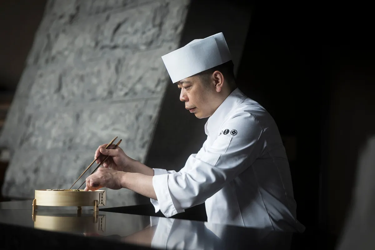 Executive Chef Junya Ikejiri plating a dish